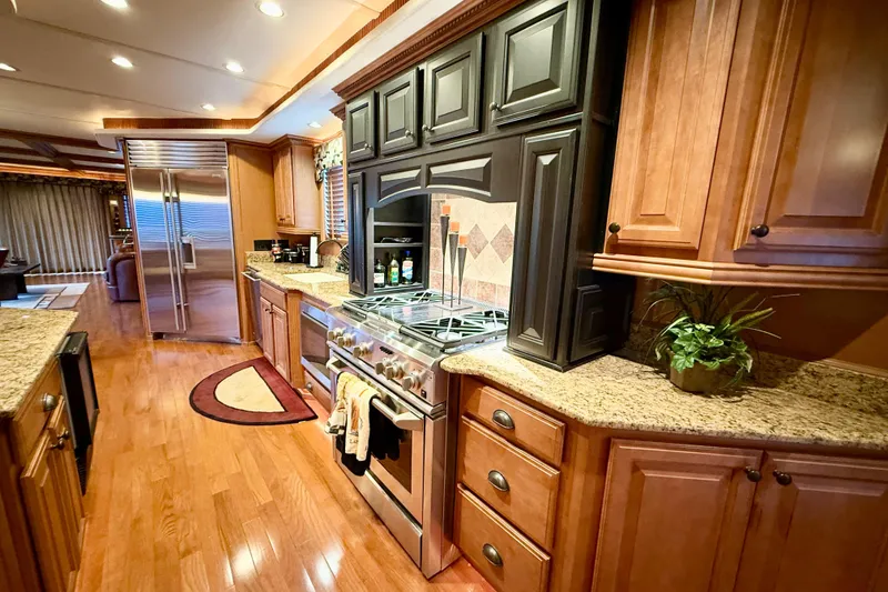 Slide: The Image of Luxurious kitchen interior of 2008 Sumerset HouseBoat with granite countertops and wooden cabinetry. - 43