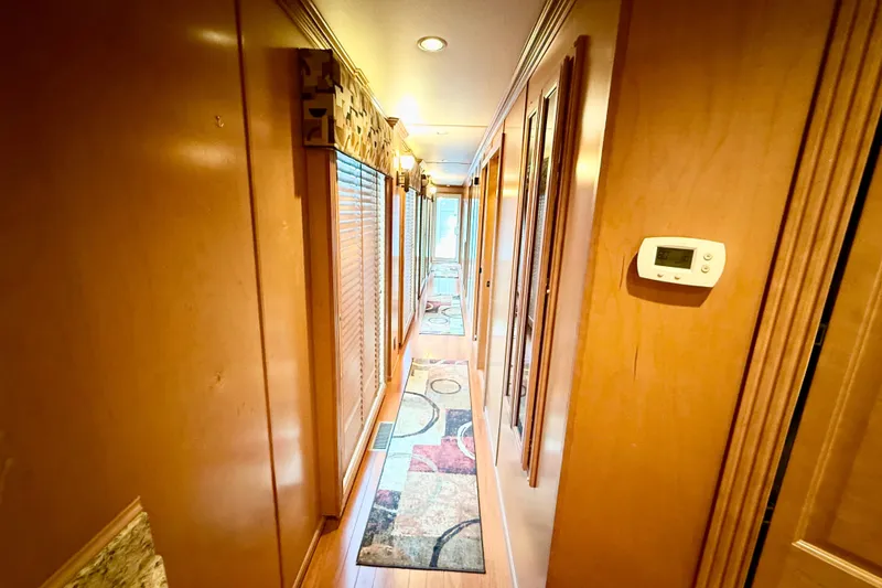 Slide: The Image of Luxurious hallway interior of 2008 Sumerset HouseBoat, featuring wood paneling and decorative rugs. - 46
