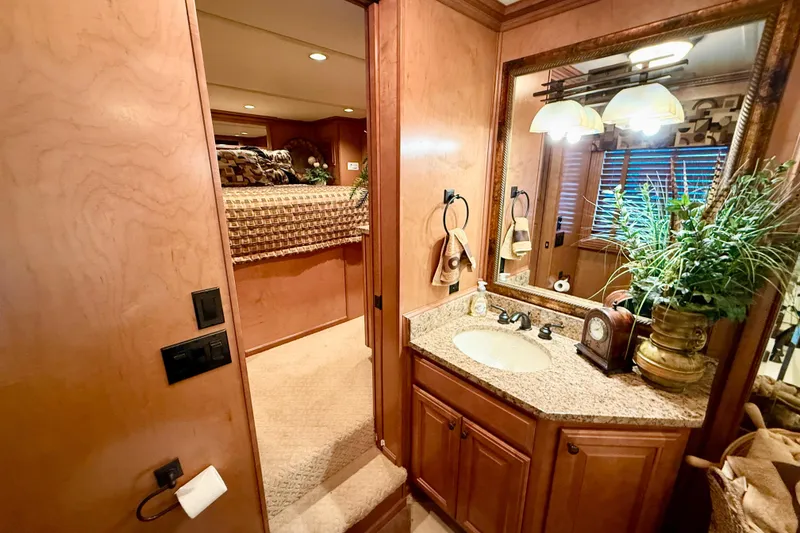 Slide: The Image of Luxurious bathroom and bedroom in 2008 Sumerset HouseBoat, featuring elegant wood finishes and decor. - 53