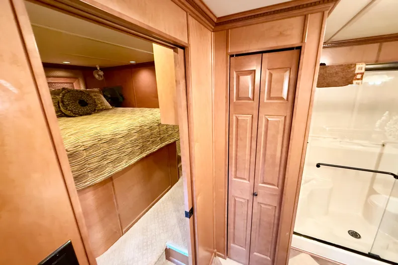 Slide: The Image of Luxurious 2008 Sumerset houseboat interior with cozy bedroom and elegant wooden finishes. - 56