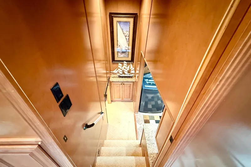 Slide: The Image of Luxurious wooden staircase inside 2008 Sumerset houseboat, featuring elegant decor and artwork. - 60