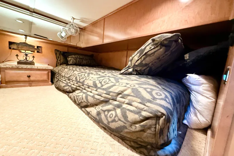 Slide: The Image of Luxurious bedroom interior of 2008 Sumerset Houseboat with patterned bedding and wooden cabinetry. - 63