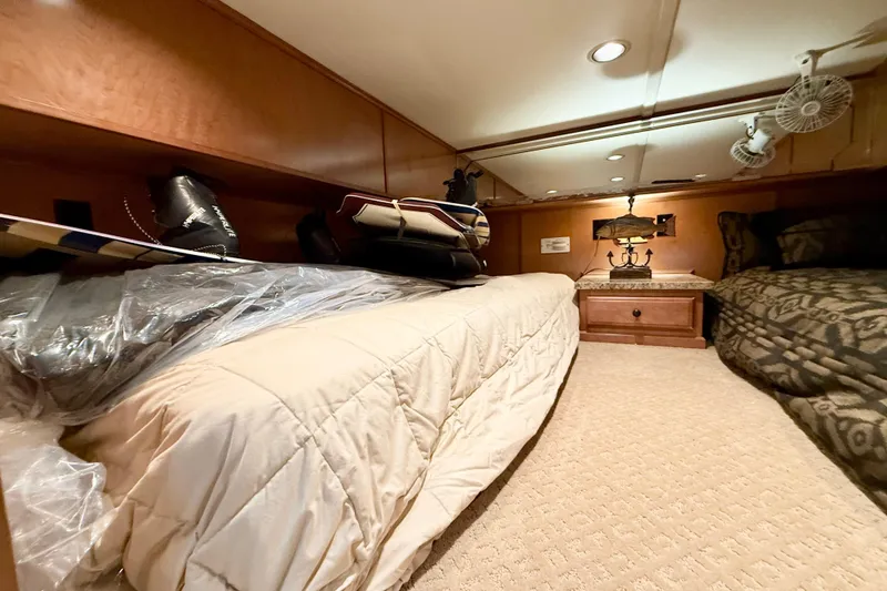 Slide: The Image of Interior of 2008 Sumerset Luxury HouseBoat bedroom with cozy beds and wooden cabinetry. - 64