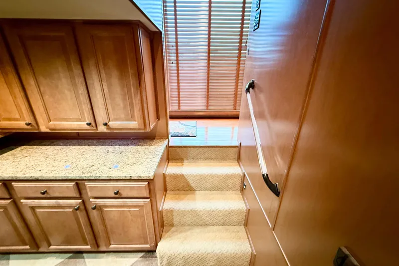 Slide: The Image of Interior of 2008 Sumerset Luxury HouseBoat with wooden cabinets and carpeted stairs. - 66