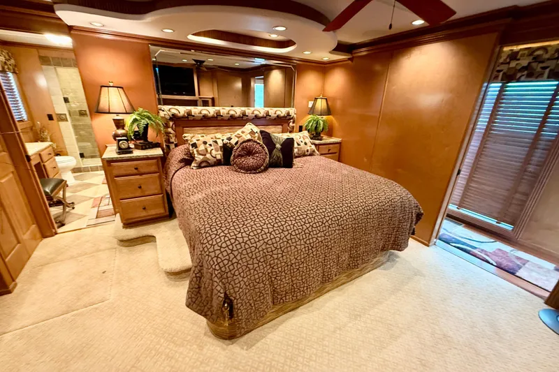 Slide: The Image of Luxurious bedroom interior of 2008 Sumerset HouseBoat, featuring elegant decor and plush bedding. - 70