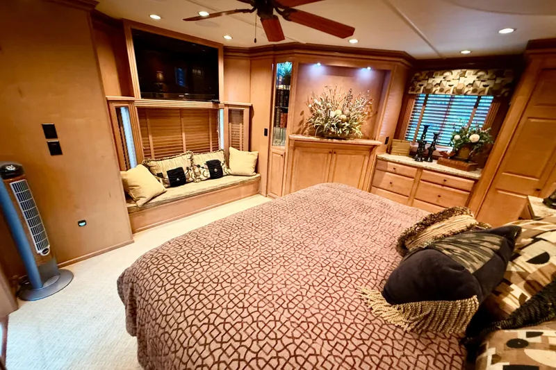 Slide: The Image of Luxurious 2008 Sumerset houseboat bedroom with elegant decor and cozy seating area. - 71