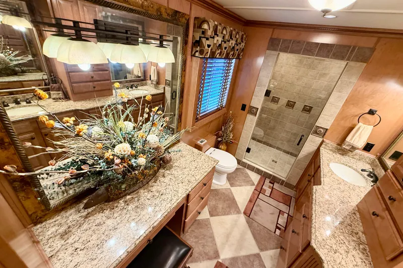 Slide: The Image of Luxurious bathroom in 2008 Sumerset houseboat with granite countertops and elegant floral arrangement. - 76