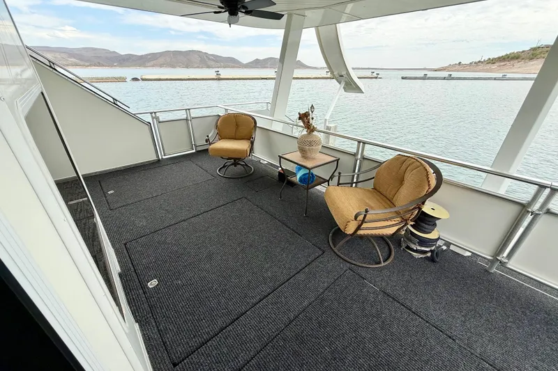 Slide: The Image of Luxurious 2008 Sumerset houseboat deck with chairs, table, and scenic water view. - 81