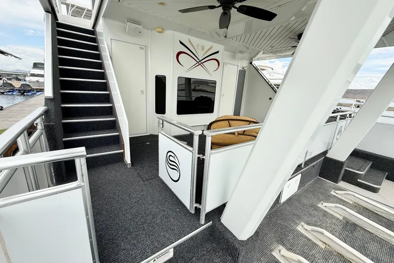 Slide: The Image of 2008 Sumerset Luxury HouseBoat interior with stairs, seating, and modern design elements. - 82