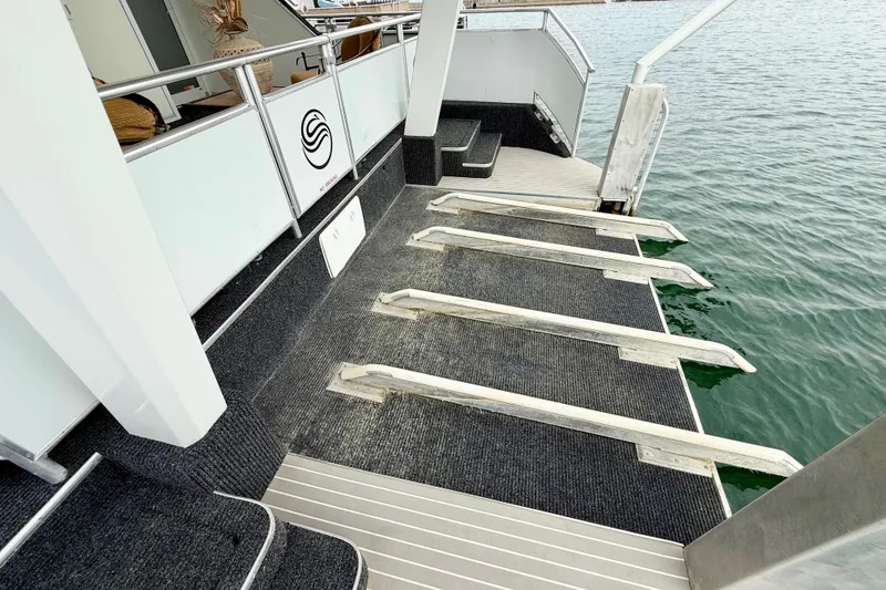 Slide: The Image of Luxury Sumerset houseboat deck with steps leading to water, 2008 model. - 83
