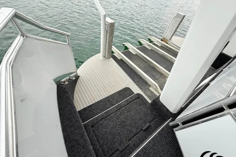 Slide: The Image of Staircase on 2008 Sumerset Luxury HouseBoat, leading to water, with sleek design and safety rails. - 84