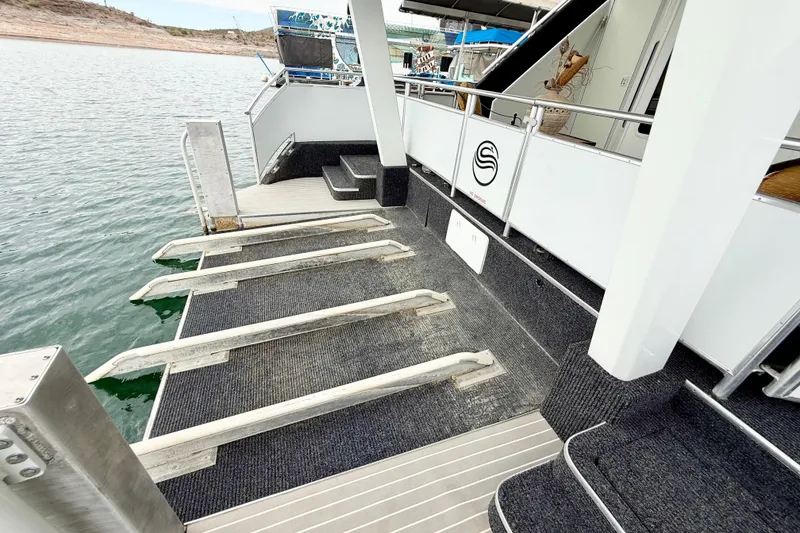 Slide: The Image of Luxury Sumerset houseboat deck with swim platform, 2008 model, on serene water. - 85