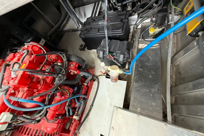 Slide: The Image of Engine room of 2008 Sumerset Luxury HouseBoat, showcasing red engine and wiring. - 89