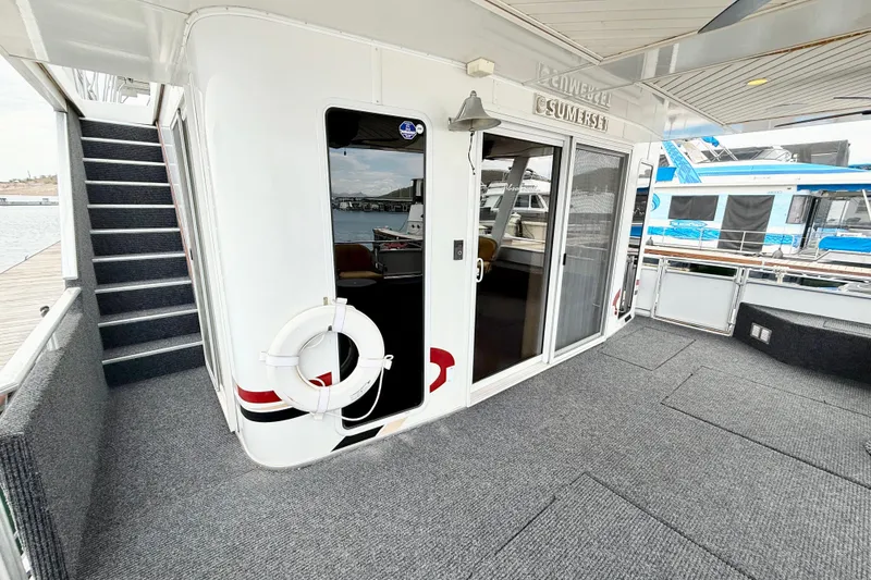Slide: The Image of Luxury Sumerset houseboat deck with stairs, sliding doors, and life preserver, 2008 model. - 9