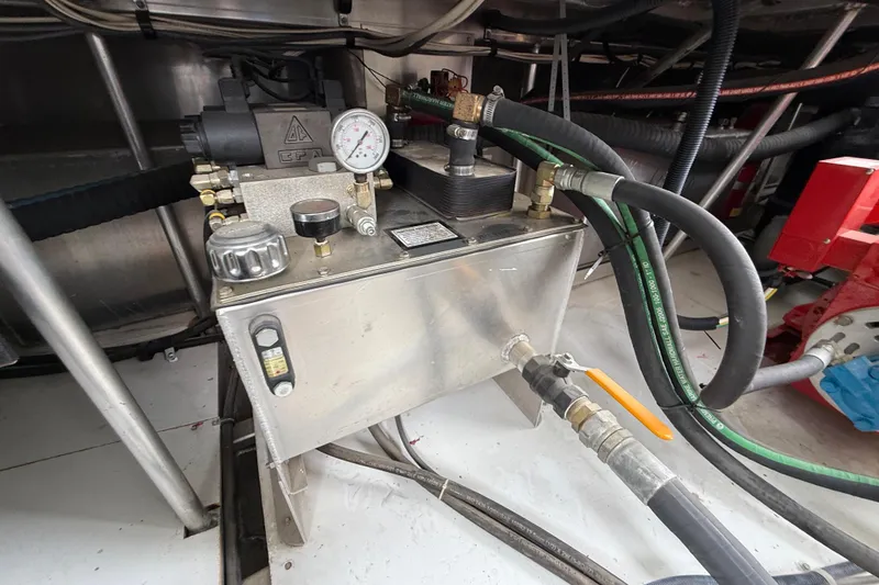 Slide: The Image of Engine room of 2008 Sumerset Luxury HouseBoat, showcasing mechanical components and hoses. - 95