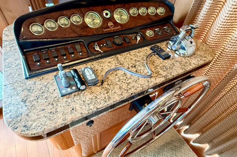 Slide: The Image of Control panel of a 2008 Sumerset Luxury HouseBoat, featuring gauges and steering wheel. - 97
