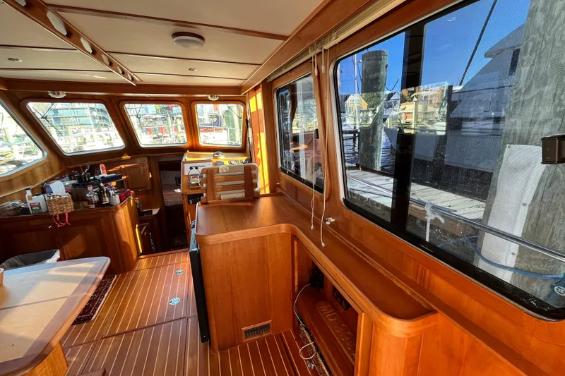 Slide: The Image of Interior of 2006 Sabre 36 Flybridge Sedan with wooden finishes and large windows. - 17