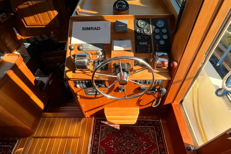 Slide: The Image of Helm of 2006 Sabre 36 Flybridge Sedan with steering wheel and navigation controls. - 23