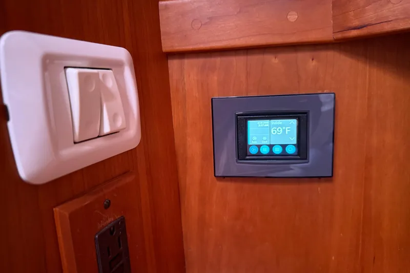 Slide: The Image of Thermostat and light switch on 2006 Sabre 36 Flybridge Sedan yacht interior. - 34