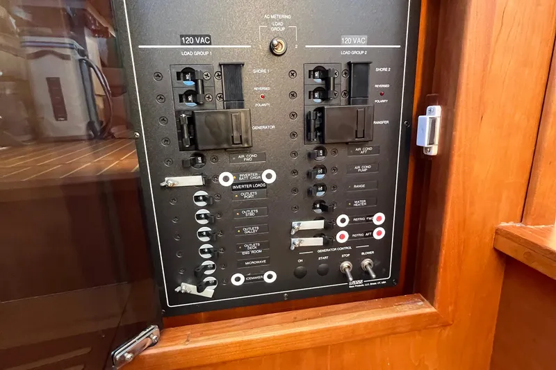 Slide: The Image of Electrical panel of 2006 Sabre 36 Flybridge Sedan boat, featuring various switches and controls. - 36