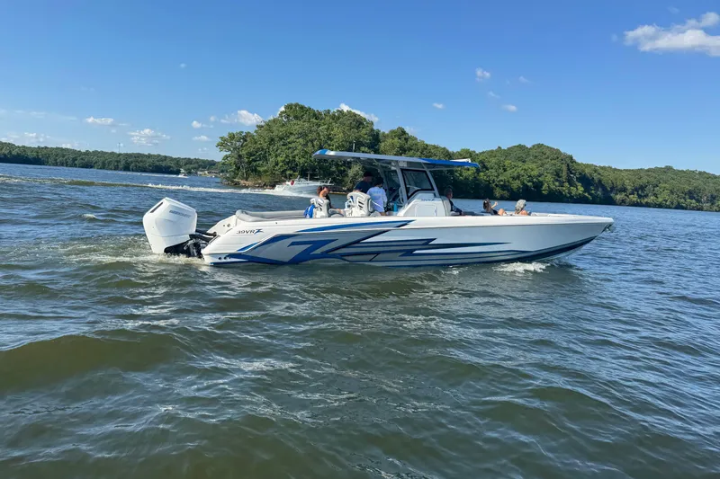 The Image of 2024 Donzi 39 VRZ boat on trailer at a gas station, showcasing sleek design. - 0