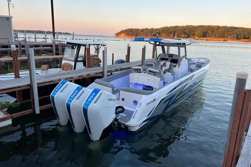 Slide: The Image of 2024 Donzi 39 VRZ boat interior with blue LED speakers and sleek gray seating. - 12