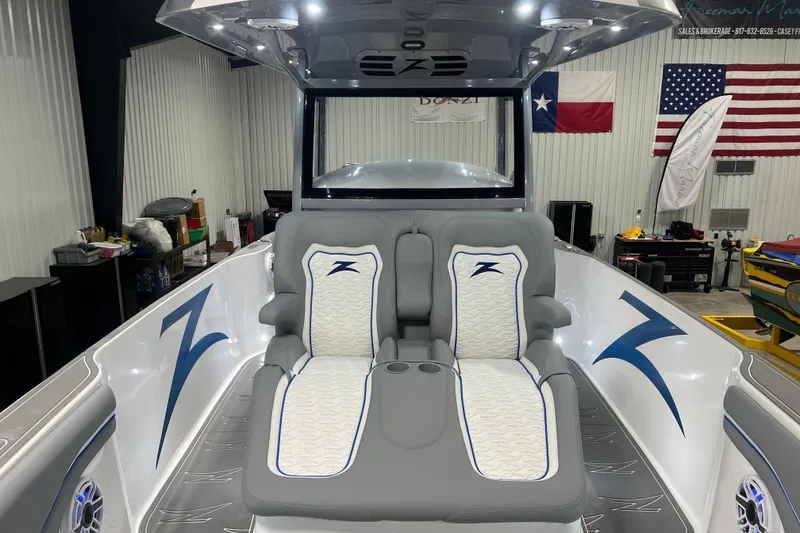 Slide: The Image of 2024 Donzi 39 VRZ boat docked, featuring triple Mercury engines, scenic waterfront view. - 13