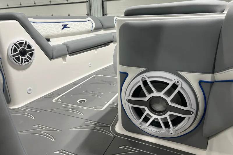 Slide: The Image of 2024 Donzi 39 VRZ boat interior with gray seating, cup holders, and speakers. - 19