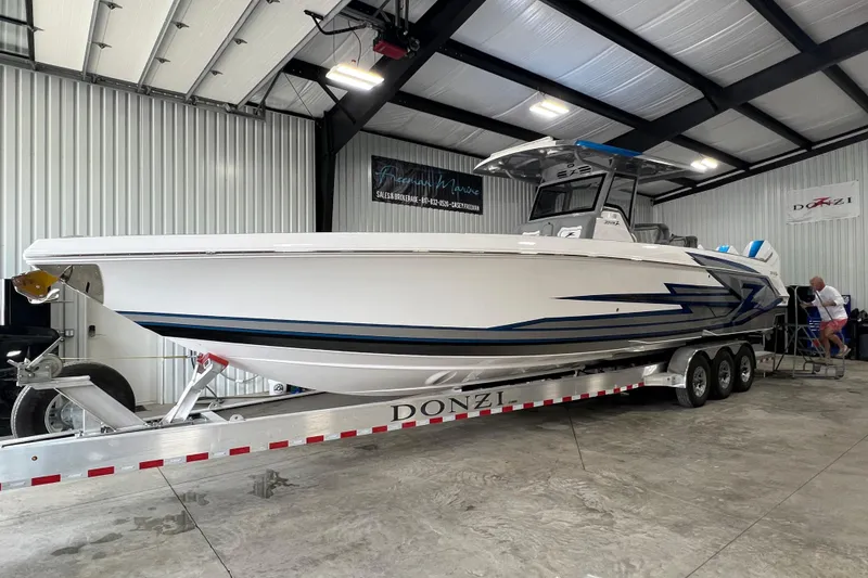 Slide: The Image of Overhead view of 2024 Donzi 39 VRZ boat docked with person sunbathing. - 2