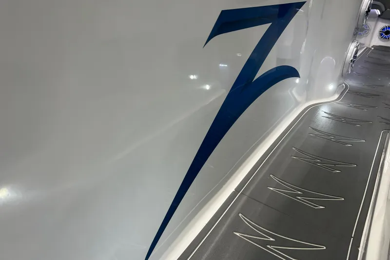 Slide: The Image of 2024 Donzi 39 VRZ boat with sleek blue logo on white hull. - 28