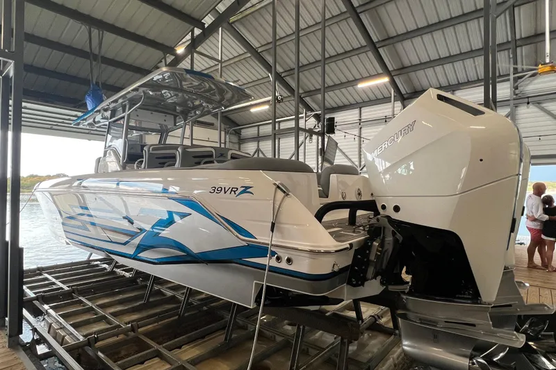Slide: The Image of 2024 Donzi 39 VRZ boat on trailer in a showroom, showcasing sleek design and modern features. - 3