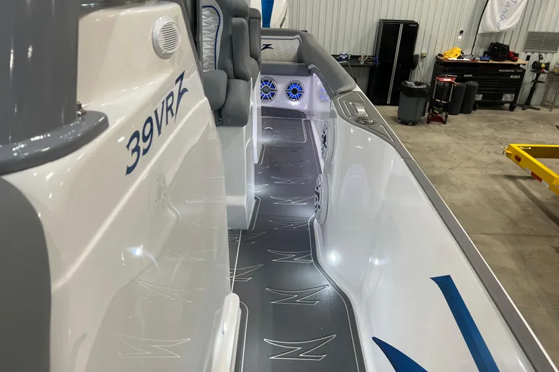 Slide: The Image of 2024 Donzi 39 VRZ boat with sleek blue and white design in showroom. - 33