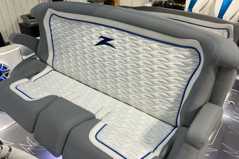 Slide: The Image of 2024 Donzi 39 VRZ boat interior with stylish gray and white seating, featuring blue accents. - 37