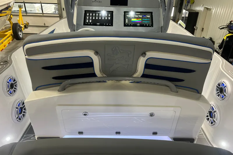 Slide: The Image of 2024 Donzi 39 VRZ boat dashboard with advanced controls and navigation screens in a garage setting. - 44