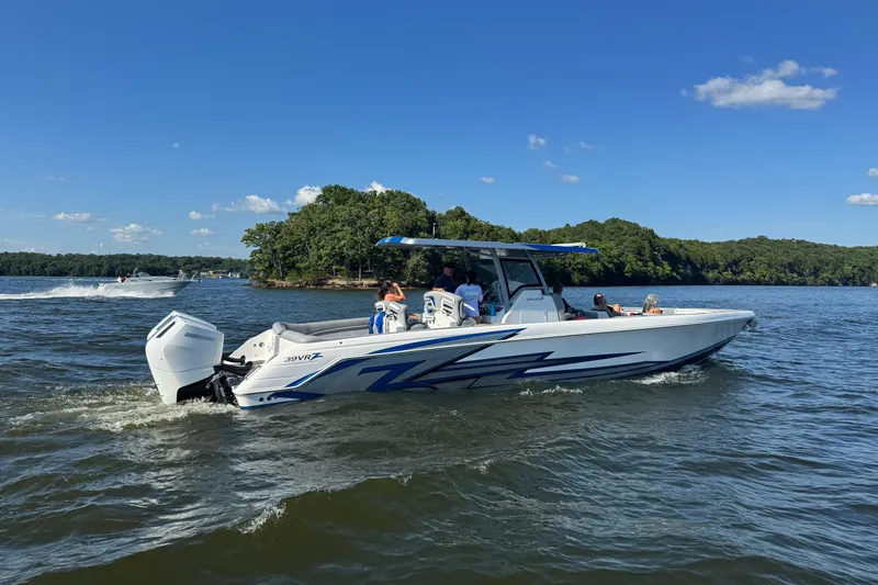 Slide: The Image of 2024 Donzi 39 VRZ boat cruising on a lake under a clear blue sky. - 5