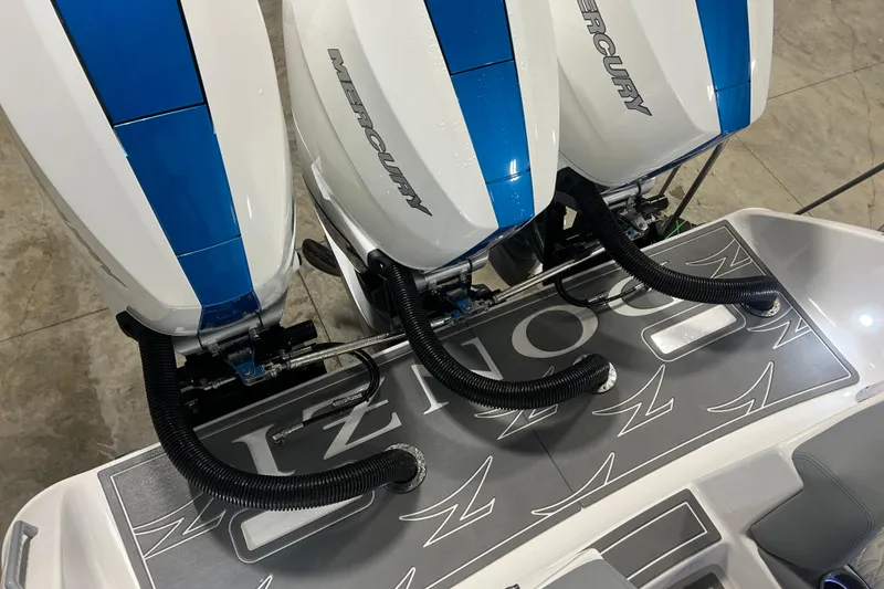 Slide: The Image of Triple Mercury outboard engines on a 2024 Donzi 39 VRZ boat in a workshop. - 57