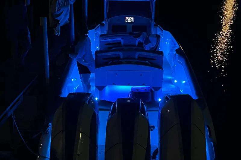 Slide: The Image of 2024 Donzi 39 VRZ boat cruising on a lake under clear blue skies. - 6