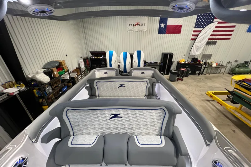 Slide: The Image of Interior view of 2024 Donzi 39 VRZ boat in a garage with flags displayed. - 62
