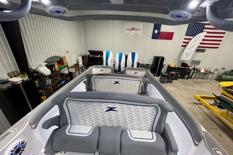 Slide: The Image of 2024 Donzi 39 VRZ boat interior with luxury seating in a workshop setting. - 63