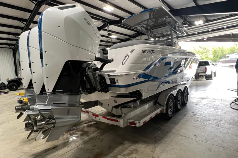 Slide: The Image of 2024 Donzi 39 VRZ boat with triple outboard engines in a showroom. - 68