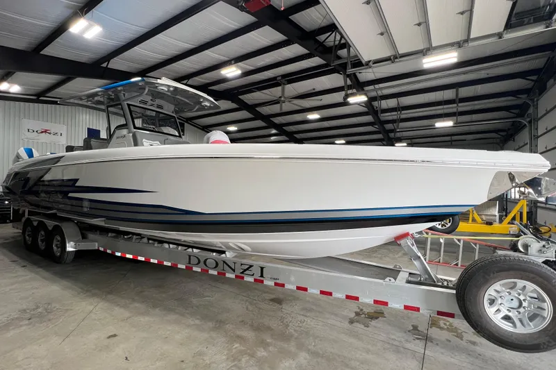 Slide: The Image of 2024 Donzi 39 VRZ boat with triple Mercury engines in a garage setting. - 69