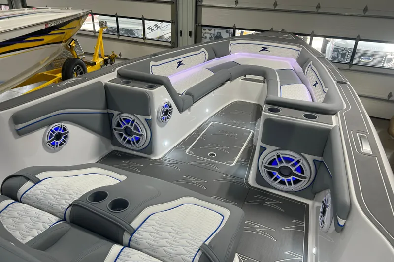 Slide: The Image of 2024 Donzi 39 VRZ boat illuminated with blue LED lights at night. - 7