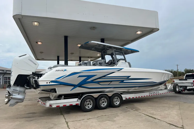 Slide: The Image of 2024 Donzi 39 VRZ boat on trailer in a spacious indoor facility. - 70