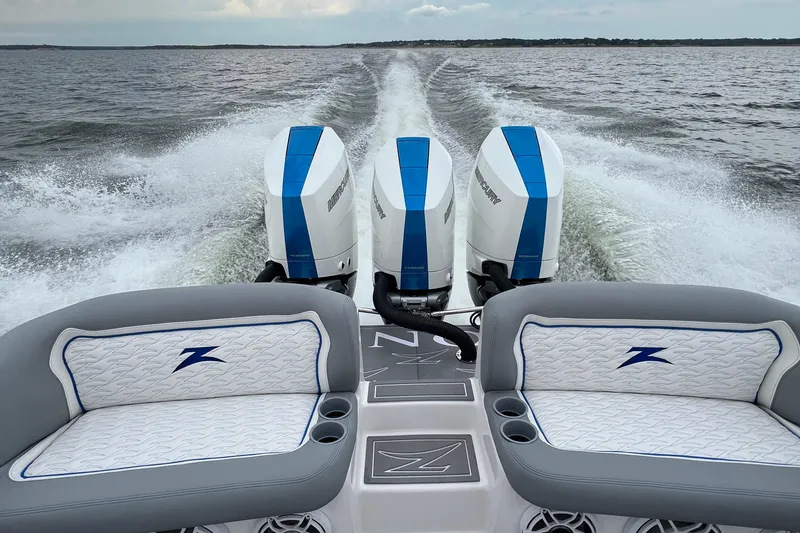 Slide: The Image of 2024 Donzi 39 VRZ boat with triple Mercury engines, cruising on open water. - 75