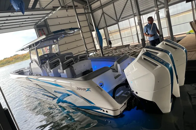 Slide: The Image of 2024 Donzi 39 VRZ boat with Mercury engines docked in a marina. - 76
