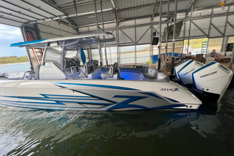 Slide: The Image of 2024 Donzi 39 VRZ boat with sleek design and powerful Mercury engines in a marina. - 79