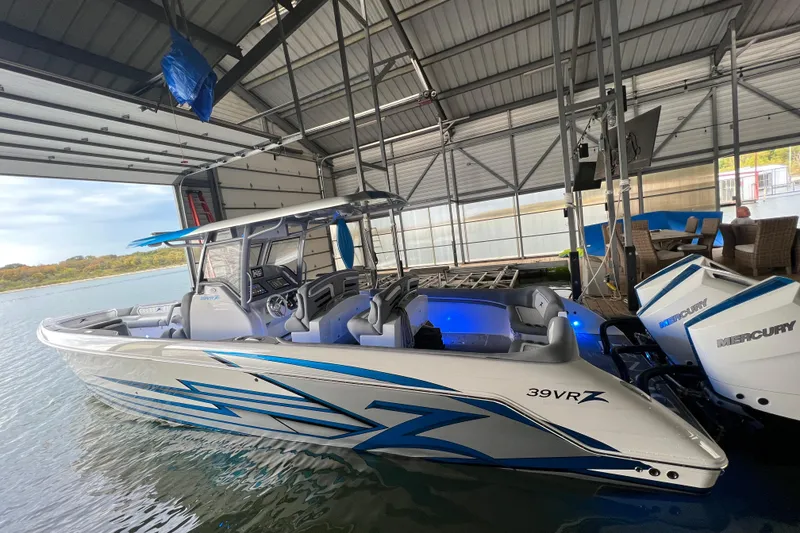 Slide: The Image of 2024 Donzi 39 VRZ boat in dock, featuring sleek design and Mercury engines. - 80