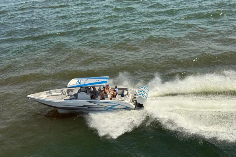 Slide: The Image of 2024 Donzi 39 VRZ speedboat cruising on open water, creating a dynamic wake. - 84