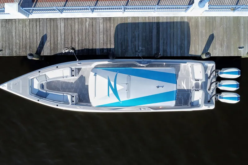 Slide: The Image of Aerial view of 2024 Donzi 39 VRZ boat docked, showcasing sleek design and triple engines. - 85