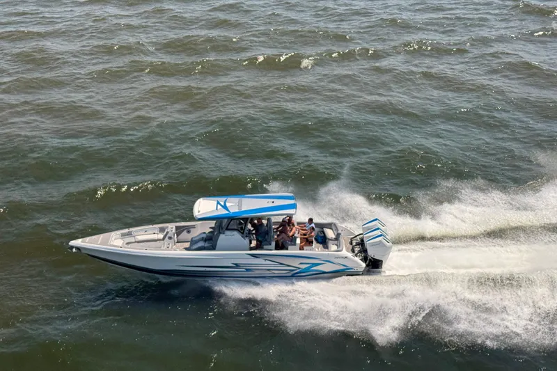 Slide: The Image of 2024 Donzi 39 VRZ speedboat cruising on open water, showcasing sleek design and performance. - 86